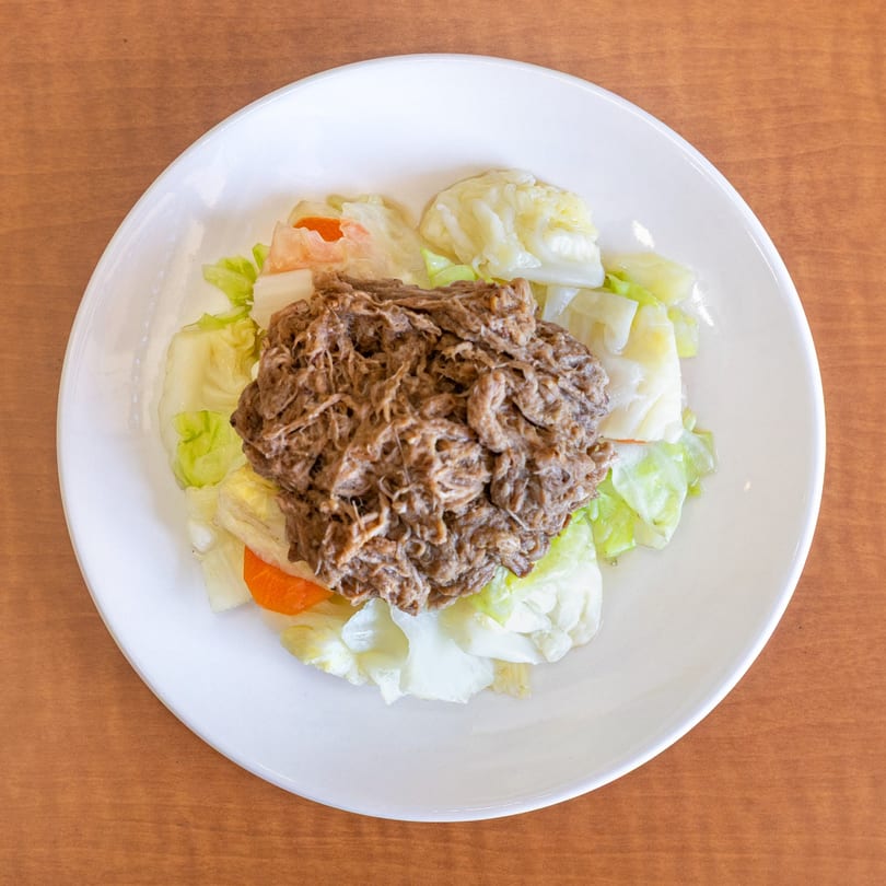 Love Hawaiian BBQ's Kalua Pork, a mound of shredded pork on a bed of cabbage and carrots.
