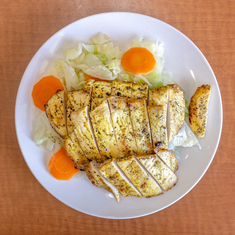 Love Hawaiian BBQ's grilled chicken, sliced and served with shredded cabbage and carrot slices.